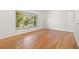 Bright and airy living room featuring sleek hardwood floors and a large window for ample natural light at 1084 39Th Ne Ave, St Petersburg, FL 33703