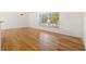 Spacious living room featuring hardwood floors, a large window, and neutral wall paint at 1084 39Th Ne Ave, St Petersburg, FL 33703