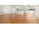 Bright, open-concept living space with gleaming hardwood floors, flowing into the kitchen and dining areas at 1084 39Th Ne Ave, St Petersburg, FL 33703