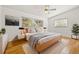 Well-furnished main bedroom with hardwood floors and bright light from the windows at 1084 39Th Ne Ave, St Petersburg, FL 33703