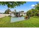 Expansive outdoor patio with seating, a grill, and lush landscaping at 1084 39Th Ne Ave, St Petersburg, FL 33703