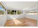 Bright sun room with large windows, hardwood floors, and natural light at 1084 39Th Ne Ave, St Petersburg, FL 33703