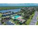 Wide aerial view of the community featuring a pool, playground, proximity to the river and lush surroundings at 110 114Th Ne Ter # 110, St Petersburg, FL 33716