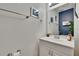 Nicely decorated half bathroom featuring a white vanity with chrome hardware at 110 114Th Ne Ter # 110, St Petersburg, FL 33716