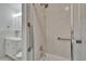 Clean bathroom showing tiled shower with grab bars and updated fixtures at 110 114Th Ne Ter # 110, St Petersburg, FL 33716
