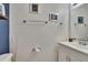 Clean half bathroom with white vanity, framed mirror, and nautical decorations at 110 114Th Ne Ter # 110, St Petersburg, FL 33716