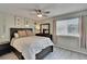 Cozy bedroom with a ceiling fan, decorative art, and lots of natural light from the window at 110 114Th Ne Ter # 110, St Petersburg, FL 33716