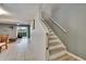 Bright hallway with stairs, tile floors, and access to the living room at 110 114Th Ne Ter # 110, St Petersburg, FL 33716
