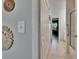 Hallway featuring an open view to a bathroom, with white tile floors and closet doors at 110 114Th Ne Ter # 110, St Petersburg, FL 33716