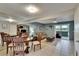 Open-concept living and dining area with neutral tile flooring and sliding glass doors at 110 114Th Ne Ter # 110, St Petersburg, FL 33716
