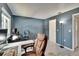 Home office with large desk, rolling chair, hardwood floors, and plenty of workspace at 110 114Th Ne Ter # 110, St Petersburg, FL 33716