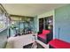 Inviting screened patio with comfortable seating, tile flooring, and lush potted plants at 110 114Th Ne Ter # 110, St Petersburg, FL 33716