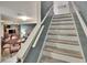 Staircase with hardwood steps leading to the second floor and connecting to the living room at 110 114Th Ne Ter # 110, St Petersburg, FL 33716