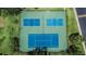 Aerial view showcases three well-maintained tennis courts for community recreation and exercise at 110 114Th Ne Ter # 110, St Petersburg, FL 33716
