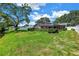 Expansive backyard featuring a screened-in pool area and well-maintained landscaping at 11250 Tradewinds Blvd, Largo, FL 33773