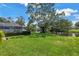 Lush backyard with green grass and mature trees provides privacy and serenity at 11250 Tradewinds Blvd, Largo, FL 33773
