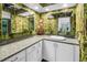 Stylish bathroom with bamboo wallpaper, white cabinets, and modern fixtures at 11250 Tradewinds Blvd, Largo, FL 33773