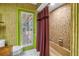 Stylish bathroom with tiled walls, standing shower, glass door and a bamboo-themed accent wall at 11250 Tradewinds Blvd, Largo, FL 33773