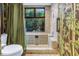 Unique tile bathroom with modern shower and bamboo accents, offering a serene and stylish space at 11250 Tradewinds Blvd, Largo, FL 33773