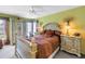 Bright bedroom with neutral walls, carpet floor, a ceiling fan, plus matching bed and dresser set at 11250 Tradewinds Blvd, Largo, FL 33773