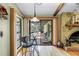 A cozy breakfast nook features a fireplace, sliding glass door to lanai, and counter seating at 11250 Tradewinds Blvd, Largo, FL 33773