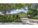 Charming single-story home with a well-manicured lawn and mature trees providing shade at 11250 Tradewinds Blvd, Largo, FL 33773