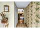 Hallway featuring decorative wallpaper, flooring, and a view of the living room at 11250 Tradewinds Blvd, Largo, FL 33773