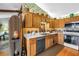 Well-lit kitchen with white counters, wooden cabinets, and stainless steel appliances at 11250 Tradewinds Blvd, Largo, FL 33773