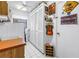 Well-organized laundry room featuring white cabinets, tile flooring, and ample storage space at 11250 Tradewinds Blvd, Largo, FL 33773