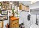 Functional laundry area with modern washer and dryer, extra cabinet space, and charming decorations at 11250 Tradewinds Blvd, Largo, FL 33773