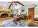 Cozy living room featuring a fireplace, hardwood floors, and natural light at 11250 Tradewinds Blvd, Largo, FL 33773