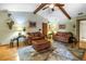 Spacious living room featuring vaulted ceilings, exposed beams, two sofas, ottoman, and decorative rug at 11250 Tradewinds Blvd, Largo, FL 33773