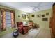 Inviting living room with bright green walls, plush seating, neutral carpet and natural light at 11250 Tradewinds Blvd, Largo, FL 33773