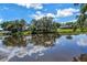 Stunning waterfront backyard and beautiful pond reflecting the gorgeous homes across the water at 11250 Tradewinds Blvd, Largo, FL 33773