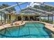 Inviting backyard pool and patio area perfect for outdoor relaxation and entertainment with a screened enclosure at 11250 Tradewinds Blvd, Largo, FL 33773
