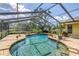 Sparkling screened-in pool with brick surround offers a relaxing outdoor oasis at 11250 Tradewinds Blvd, Largo, FL 33773