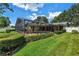 A view of the pool area surrounded by lush green landscaping, with privacy fencing at 11250 Tradewinds Blvd, Largo, FL 33773