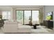 Comfortable living room showcasing a sectional sofa, sliding glass doors, and stylish decor at 11518 Flourish Dr, Land O Lakes, FL 34637