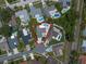 Overhead view of home and neighborhood, with a swimming pool, fenced yard and mature trees at 11763 Saree Ct, Largo, FL 33778