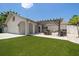 Inviting backyard featuring a pergola, an outdoor kitchen area, and well-maintained artificial grass for a seamless look at 11763 Saree Ct, Largo, FL 33778