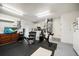 Basement with fitness equipment, TV, rubber floor, white door and cabinetry at 11763 Saree Ct, Largo, FL 33778