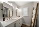 Bathroom features a double sink vanity, framed mirrors, and decorative ladder with towels at 11763 Saree Ct, Largo, FL 33778