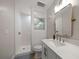 Contemporary bathroom includes shower, toilet, and vanity with framed mirror at 11763 Saree Ct, Largo, FL 33778
