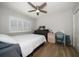 Bedroom with ceiling fan, window, bed, and dresser with TV, and unique accent furniture at 11763 Saree Ct, Largo, FL 33778