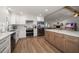 Open kitchen boasts stainless steel appliances, wood cabinets, and a view into the living area at 11763 Saree Ct, Largo, FL 33778