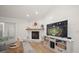 Cozy living room with fireplace, television and shiplap walls, with an adjacent seating area at 11763 Saree Ct, Largo, FL 33778