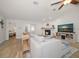 Bright living room with shiplap walls, fireplace, ceiling fan, and views to the bedroom at 11763 Saree Ct, Largo, FL 33778