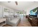 Living room featuring large sectional and sliding doors that lead to outdoor pool at 11763 Saree Ct, Largo, FL 33778