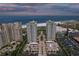 Aerial view displays beachfront condos with lush surroundings, parking, and close proximity to the ocean and sandy beach at 1180 Gulf Blvd # 504, Clearwater Beach, FL 33767