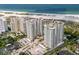 Scenic aerial view of beachfront condos and lush landscaping with parking at 1180 Gulf Blvd # 504, Clearwater Beach, FL 33767
